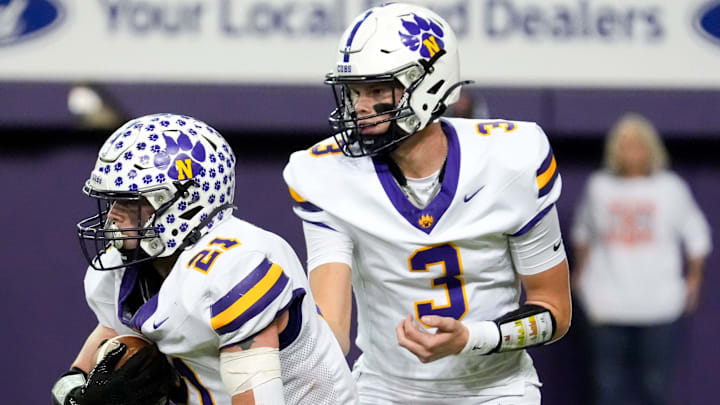 Nevada quarterback Drake Hinson (3) hands the ball off to Nevada running back Austin Waldera (21) Nov. 15, 2025 during a Class 3A Iowa high school football semifinal at the UNI-Dome in Cedar Falls, Iowa.
