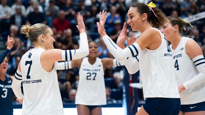 Penn State women's volleyball right side hitter Kennedy Martin high-fives setter Addie Lyon after a point during a Big Ten volleyball match against UCLA