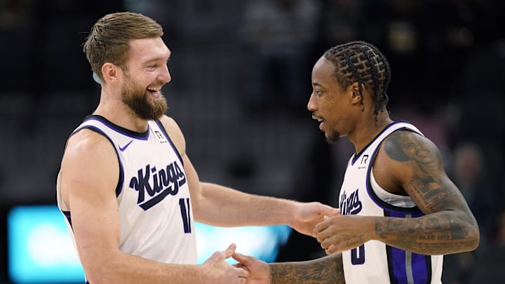 Dec 6, 2024; San Antonio, Texas, USA; Sacramento Kings center Domantas Sabonis (11) and forward DeMar DeRozan (10) embrace before a game the San Antonio Spurs at Frost Bank Center.