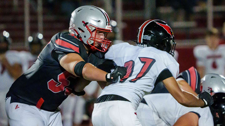 Morton lineman Soren Fifer, left, protects the quarterback in the second half of their Week 4 high school football game against Metamora on Friday, Sept. 19, 2025 in Morton. The Redbirds defeated the Potters 43-40.