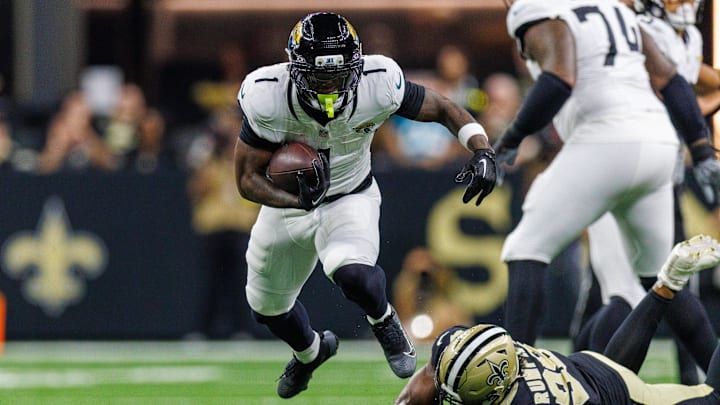 Aug 17, 2025; New Orleans, Louisiana, USA; Jacksonville Jaguars running back Travis Etienne Jr. (1) leaps to avoid the tackle of New Orleans Saints defensive end Chris Rumph II (98) during the first half at Caesars Superdome. Aug 17, 2025; New Orleans, Louisiana, USA; Jacksonville Jaguars running back Travis Etienne Jr. (1) leaps to avoid the tackle of New Orleans Saints defensive end Chris Rumph II (98) during the first half at Caesars Superdome.