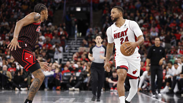 Nov 21, 2025; Chicago, Illinois, USA; Chicago Bulls forward Dalen Terry (7) defends against Miami Heat guard Norman Powell (24) during the second half at United Center. Mandatory Credit: Kamil Krzaczynski-Imagn Images