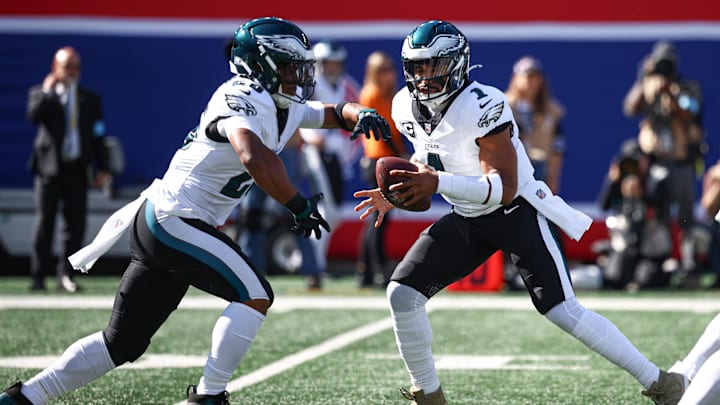 Oct 20, 2024; East Rutherford, New Jersey, USA; Philadelphia Eagles quarterback Jalen Hurts (1) fakes a hand off to running back Saquon Barkley (26) during the first half against the New York Giants at MetLife Stadium. Mandatory Credit: Vincent Carchietta-Imagn Images