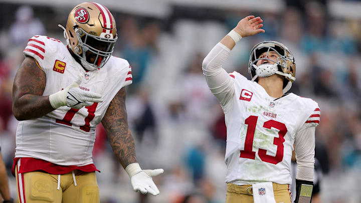 San Francisco 49ers left tackle Trent Williams (L) and quarterback Brock Purdy (R)