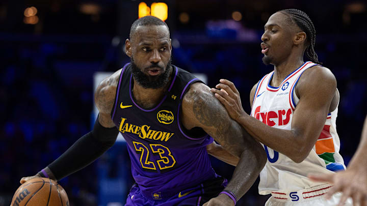 Jan 28, 2025; Philadelphia, Pennsylvania, USA; Los Angeles Lakers forward LeBron James (23) controls the ball against Philadelphia 76ers guard Tyrese Maxey (0) during the second quarter at Wells Fargo Center. Mandatory Credit: Bill Streicher-Imagn Images