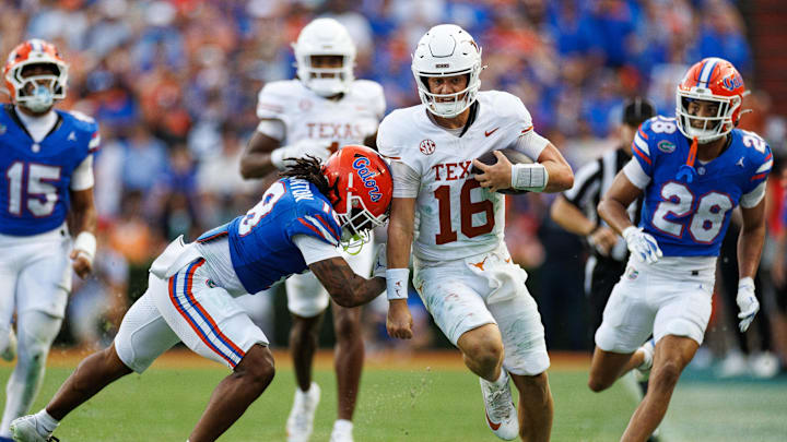 Florida Gators linebacker Aaron Chiles (8) pushes Texas Longhorns quarterback Arch Manning (16) out of bounds during the second half at Ben Hill Griffin Stadium.