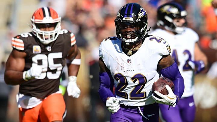 Oct 27, 2024; Cleveland, Ohio, USA; Baltimore Ravens running back Derrick Henry (22) runs with the ball as Cleveland Browns defensive end Myles Garrett (95) pursues during the first half at Huntington Bank Field. Mandatory Credit: Ken Blaze-Imagn Images