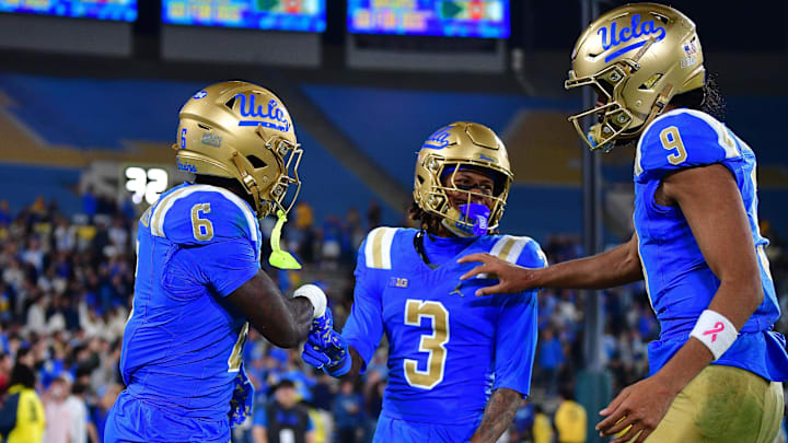 Nov 8, 2025; Pasadena, California, USA; UCLA Bruins running back Anthony Woods (6) celebrates his touchdown scored against the Nebraska Cornhuskers with wide receiver Kwazi Gilmer (3) and quarterback Nico Iamaleava (9) during the second half at the Rose Bowl. Mandatory Credit: Gary A. Vasquez-Imagn Images