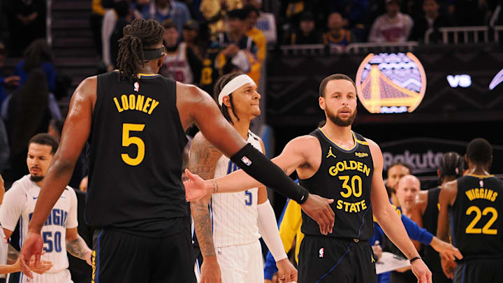 Feb 3, 2025; San Francisco, California, USA; Golden State Warriors guard Stephen Curry (30) high fives forward Kevon Looney (5) as a timeout is called during the fourth quarter against the Orlando Magic at Chase Center. Mandatory Credit: Kelley L Cox-Imagn Images