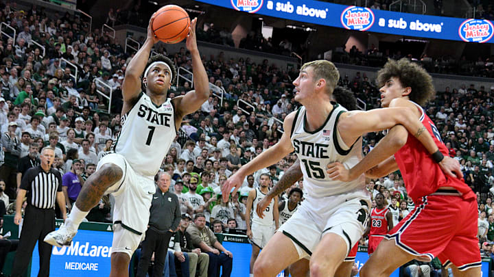 Nov 21, 2025; East Lansing, Michigan, USA; Michigan State Spartans guard Jeremy Fears Jr. (1) drives to the basket during the second half while Michigan State Spartans center Carson Cooper (15) clears a lane for him against the Detroit Mercy Titans at Jack Breslin Student Events Center. Mandatory Credit: Dale Young-Imagn Images Nov 21, 2025; East Lansing, Michigan, USA; Michigan State Spartans guard Jeremy Fears Jr. (1) drives to the basket during the second half while Michigan State Spartans center Carson Cooper (15) clears a lane for him against the Detroit Mercy Titans at Jack Breslin Student Events Center. Mandatory Credit: Dale Young-Imagn Images