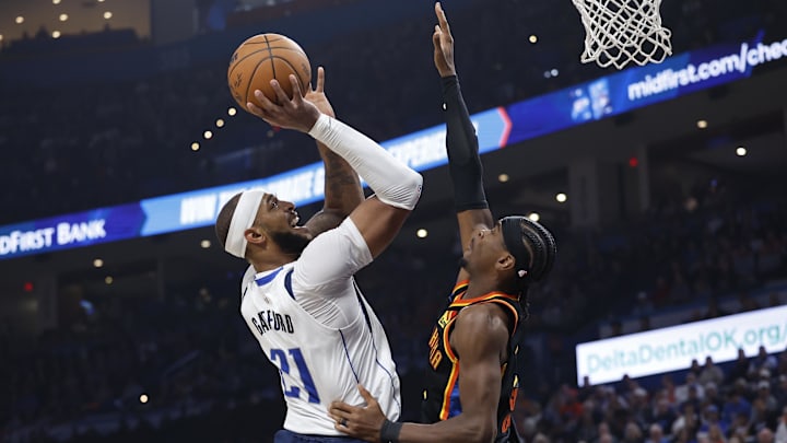 Nov 17, 2024; Oklahoma City, Oklahoma, USA; Dallas Mavericks center Daniel Gafford (21) shoots as Oklahoma City Thunder guard Shai Gilgeous-Alexander (2) defends during the second quarter at Paycom Center. Mandatory Credit: Alonzo Adams-Imagn Images Nov 17, 2024; Oklahoma City, Oklahoma, USA; Dallas Mavericks center Daniel Gafford (21) shoots as Oklahoma City Thunder guard Shai Gilgeous-Alexander (2) defends during the second quarter at Paycom Center. Mandatory Credit: Alonzo Adams-Imagn Images