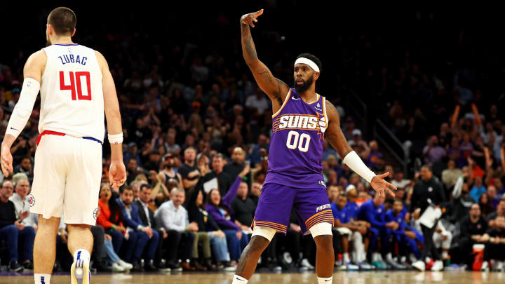 Apr 9, 2024; Phoenix, Arizona, USA;  Phoenix Suns forward Royce O'Neale (00) celebrates after a play against LA Clippers center Ivica Zubac (40) during the fourth quarter at Footprint Center. Mandatory Credit: Mark J. Rebilas-USA TODAY Sports
