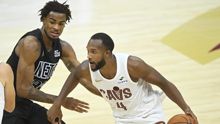Nov 9, 2024; Cleveland, Ohio, USA; Cleveland Cavaliers forward Evan Mobley (4) dribbles beside Brooklyn Nets center Nic Claxton (33) in the third quarter at Rocket Mortgage FieldHouse. Mandatory Credit: David Richard-Imagn Images