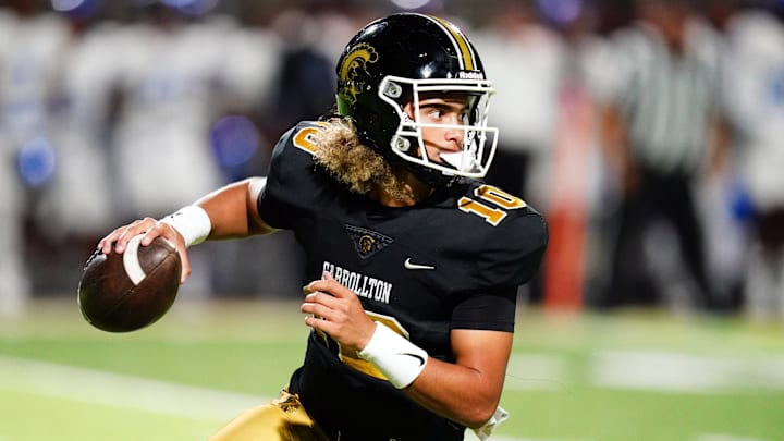 Oct 20, 2023; Carrollton, GA, USA; Carrollton Trojans quarterback Julian Lewis (10) scrambles out of the pocket against the Westlake Lions during the first half at Grisham Stadium. The 15-year-old Carrollton High student has already committed to playing for the University of Southern California Trojans and has been considered one of the top high school quarterback prospects. Mandatory Credit: John David Mercer-Imagn Images