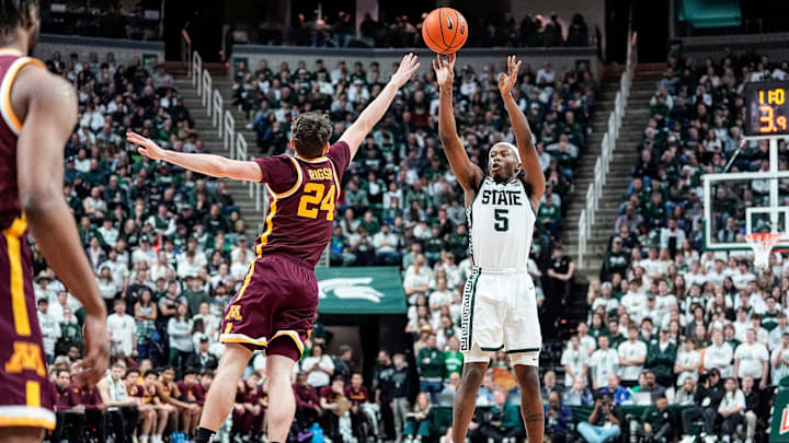 Michigan State guard Tre Holloman (5) makes a jump shot against Minnesota guard Brennan Rigsby (24) during the second half at Breslin Center in East Lansing on Tuesday, Jan. 28, 2025.