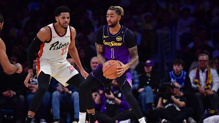 Dec 23, 2024; Los Angeles, California, USA; Los Angeles Lakers guard D'Angelo Russell (1) controls the ball against Detroit Pistons forward Tobias Harris (12) during the first half at Crypto.com Arena. Mandatory Credit: Gary A. Vasquez-Imagn Images
