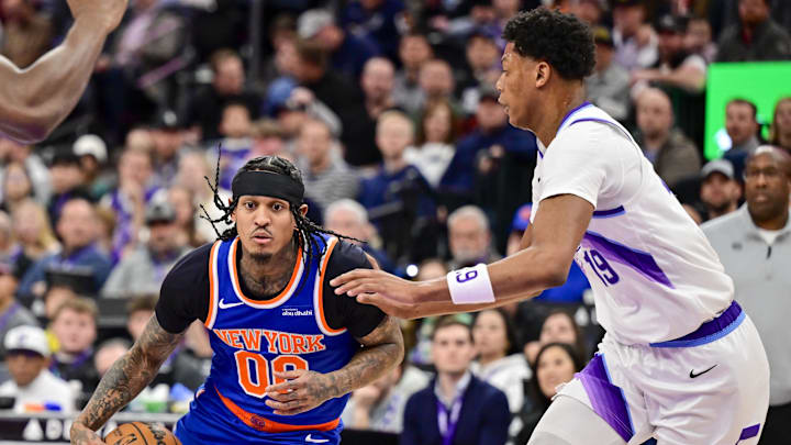 Mar 11, 2026; Salt Lake City, Utah, USA; New York Knicks guard Jordan Clarkson (00) drives into Utah Jazz forward Ace Bailey (19) during the first half at Delta Center. Mandatory Credit: Peter Creveling-Imagn Images