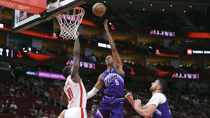 Oct 8, 2025; Houston, Texas, USA; Utah Jazz forward Cody Williams (5) shoots the ball as Houston Rockets center Clint Capela (30) defends during the second quarter at Toyota Center. Mandatory Credit: Troy Taormina-Imagn Images