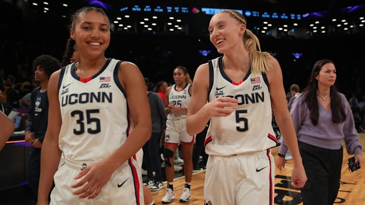 Dec 7, 2024; Brooklyn, New York, USA; Connecticut Huskies guard Azzi Fudd (35) and Connecticut Huskies guard Paige Bueckers (5) celebrate after the game against the Louisville Cardinals at Barclays Center. Mandatory Credit: Lucas Boland-Imagn Images