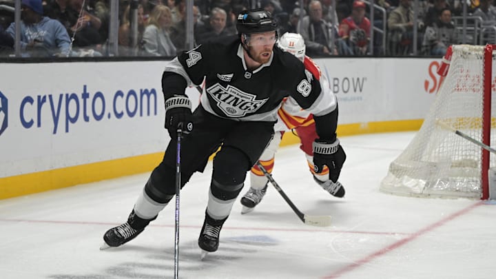 Apr 17, 2025; Los Angeles, California, USA;  Los Angeles Kings defenseman Vladislav Gavrikov (84) controls the puck during the second period at Crypto.com Arena. Mandatory Credit: Jayne Kamin-Oncea-Imagn Images