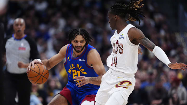 Feb 9, 2026; Denver, Colorado, USA; Cleveland Cavaliers guard Keon Ellis (14) defends on Denver Nuggets guard Jamal Murray (27) in the second quarter at Ball Arena. Mandatory Credit: Ron Chenoy-Imagn Images