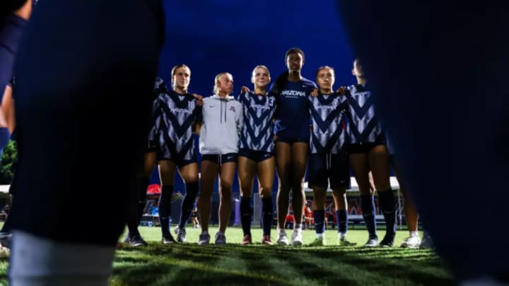 The Arizona soccer team huddled together before the stater of a match.