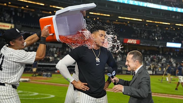 Sep 12, 2024; Bronx, New York, USA; New York Yankees shortstop Anthony Volpe (11) and center fielder Aaron Judge (99) dump gatorade on right fielder Juan Soto (22) for getting the game winning hit while being interviewed by Fox Broadcaster Ken Rosenthal after the game against the Boston Red Sox at Yankee Stadium. Mandatory Credit: Gregory Fisher-Imagn Images