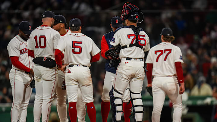 Apr 21, 2026; Boston, Massachusetts, USA; Boston Red Sox pitcher Jack Anderson (77) is relived by manager Alex Cora (13) as they take on the New York Yankees in the eighth inning at Fenway Park. Mandatory Credit: David Butler II-Imagn Images