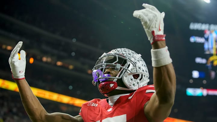 Ohio State Buckeyes wide receiver Carnell Tate (17) celebrates a touchdown Saturday, Dec. 6, 2025, during the Big Ten football championship against the Indiana Hoosiers at Lucas Oil Stadium in Indianapolis.