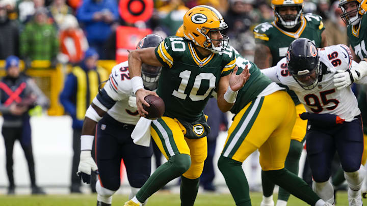 Jan 5, 2025; Green Bay, Wisconsin, USA;  Green Bay Packers quarterback Jordan Love (10) scrambles to avoid pressure during the first quarter against the Chicago Bears at Lambeau Field. Mandatory Credit: Jeff Hanisch-Imagn Images