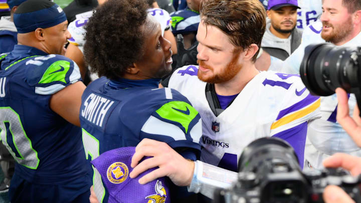 Dec 22, 2024; Seattle, Washington, USA; Seattle Seahawks quarterback Geno Smith (7) and Minnesota Vikings quarterback Sam Darnold (14) hug after the game at Lumen Field. 