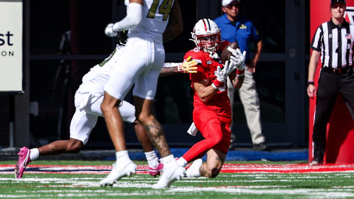 Oct 19, 2024; Tucson, Arizona, USA; Arizona Wildcats defensive back Jack Luttrell (13) intercepts a ball against the Colorado Buffaloes during the second quarter at Arizona Stadium. 