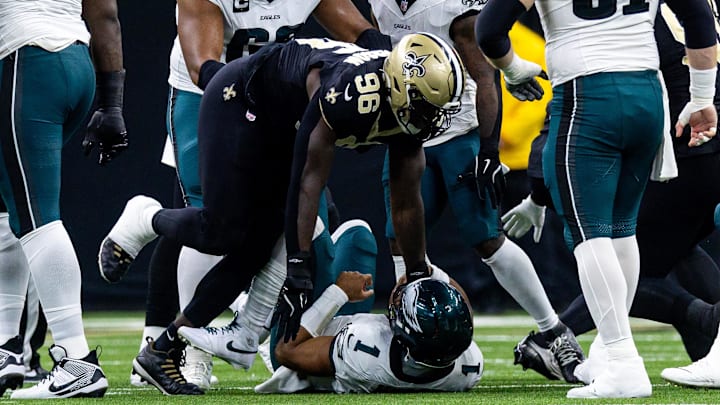 Philadelphia Eagles quarterback Jalen Hurts is sacked by New Orleans Saints defensive end Payton Turner