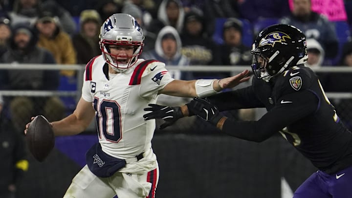 Dec 21, 2025; Baltimore, Maryland, USA;  New England Patriots quarterback Drake Maye (10) runs from Baltimore Ravens linebacker Kyle van Noy (53) during the first half of the game at M&T Bank Stadium. Mandatory Credit: James Lang-Imagn Images