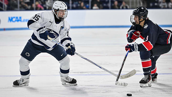 Penn State hockey player Tessa Janecke goes for the puck against UConn during a Nittany Lions hockey game.