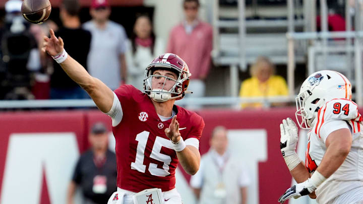 Nov 16, 2024; Tuscaloosa, AL, USA; Alabama Crimson Tide quarterback Ty Simpson (15) rolls out and throws with Mercer defensive lineman Andrew Zock (94) pressuring him at Bryant-Denny Stadium. Alabama defeated Mercer 52-7. Mandatory Credit: Gary Cosby Jr.-Tuscaloosa News