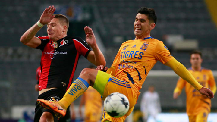 Julio Furch y Jesús Angulo pelean un balón.