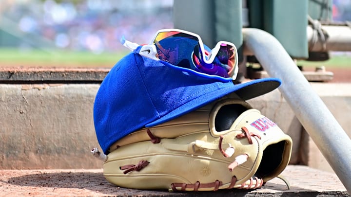 Feb 27, 2024; Mesa, Arizona, USA; General view of a Chicago Cubs glove, hat and glasses in the first inning against the Cincinnati Reds during a spring training game at Sloan Park. Mandatory Credit: Matt Kartozian-Imagn Images Feb 27, 2024; Mesa, Arizona, USA; General view of a Chicago Cubs glove, hat and glasses in the first inning against the Cincinnati Reds during a spring training game at Sloan Park. Mandatory Credit: Matt Kartozian-Imagn Images