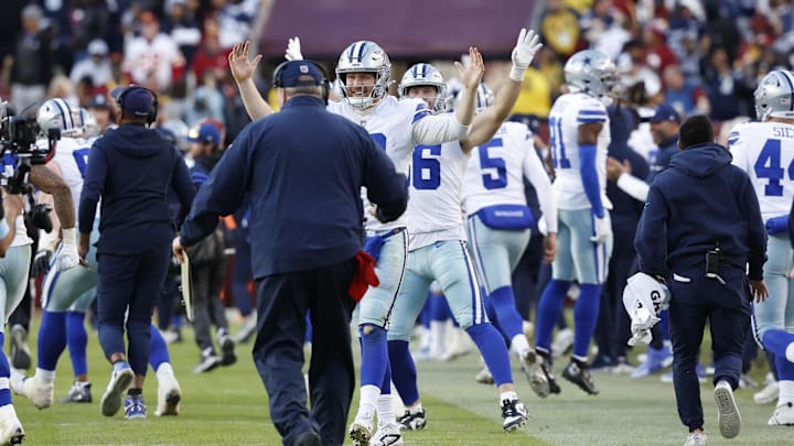 Dallas Cowboys quarterback Cooper Rush celebrates with Cowboys head coach Mike McCarthy after a kickoff return for a touchdown by Cowboys wide receiver KaVontae Turpin.