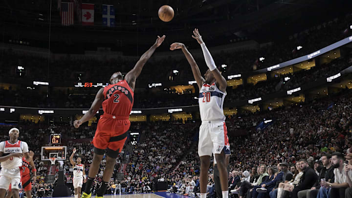 Oct 6, 2024; Montreal, Quebec, CAN; Washington Wizards power forward Alex Sarr (20) takes a jumps shot over Toronto Raptors forward Jonathan Mogbo (2) during the second quarter at the Bell Centre. Mandatory Credit: Eric Bolte-Imagn Images
