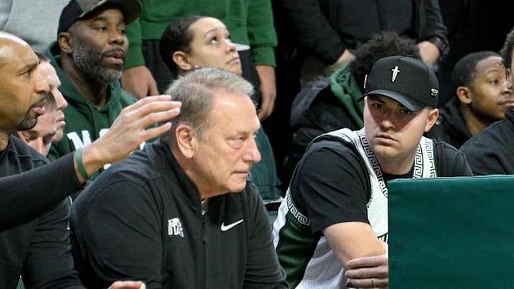 Jan 19, 2025; East Lansing, Michigan, USA;  Tigers Cy Young award winner Tarik Skubal watches Michigan State Spartans head coach Tom Izzo during the first half against the Illinois Fighting Illini at Jack Breslin Student Events Center. Mandatory Credit: Dale Young-Imagn Images