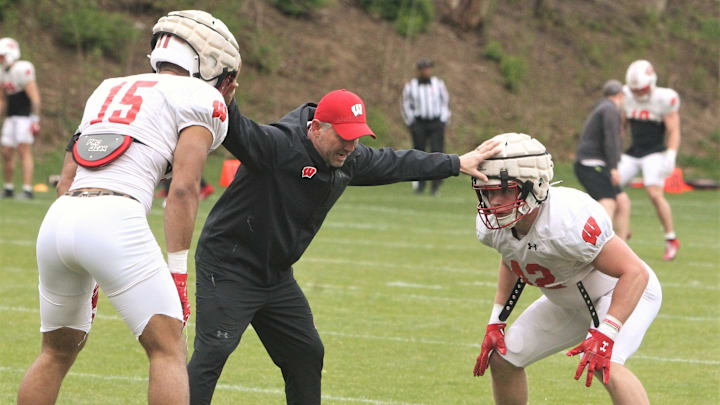 Defensive coordinator Mike Tressel works with linebackers Sebastian Cheeks (14) and Tyler Jansey (42) during the team's 10th spring practice, which was held on a practice field north of Camp Randall Stadium in Madison, Wisconsin on Saturday April 20, 2024.