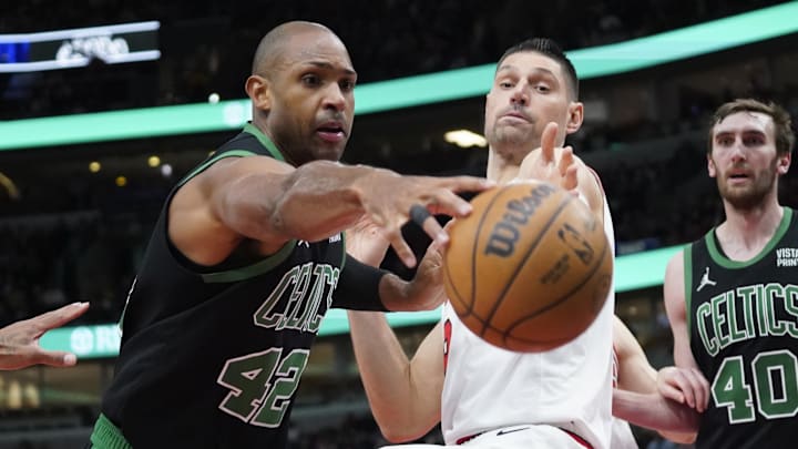 Mar 23, 2024; Chicago, Illinois, USA; Chicago Bulls center Nikola Vucevic (9) and Boston Celtics center Al Horford (42) go for the ball during the second half at United Center. Mandatory Credit: David Banks-Imagn Images