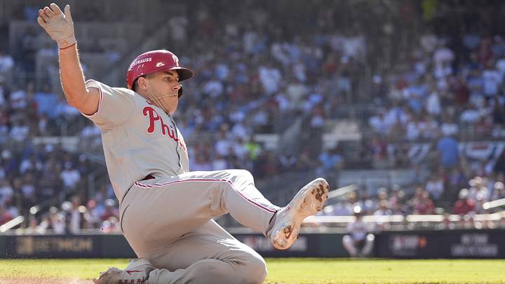 Sep 29, 2026; Cumberland, Georgia, USA; Philadelphia Phillies catcher J.T. Realmuto (10) slides safely after hitting a triple in the seventh inning during game one of the Wildcard round for the 2026 MLB Playoffs at Truist Park. Mandatory Credit: Dale Zanine-Imagn Images Sep 29, 2026; Cumberland, Georgia, USA; Philadelphia Phillies catcher J.T. Realmuto (10) slides safely after hitting a triple in the seventh inning during game one of the Wildcard round for the 2026 MLB Playoffs at Truist Park. Mandatory Credit: Dale Zanine-Imagn Images