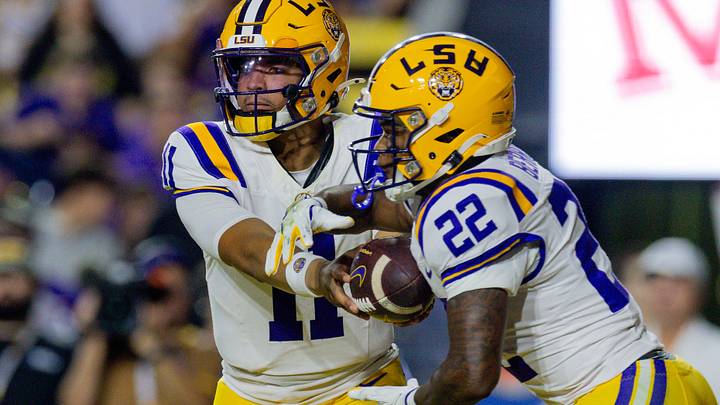 Nov 22, 2025; Baton Rouge, Louisiana, USA; LSU Tigers quarterback Michael van Buren Jr. (11) hands the ball off to running back Harlem Berry (22) against the Western Kentucky Hilltoppers during the first half at Tiger Stadium. Mandatory Credit: Stephen Lew-Imagn Images Nov 22, 2025; Baton Rouge, Louisiana, USA; LSU Tigers quarterback Michael van Buren Jr. (11) hands the ball off to running back Harlem Berry (22) against the Western Kentucky Hilltoppers during the first half at Tiger Stadium. Mandatory Credit: Stephen Lew-Imagn Images