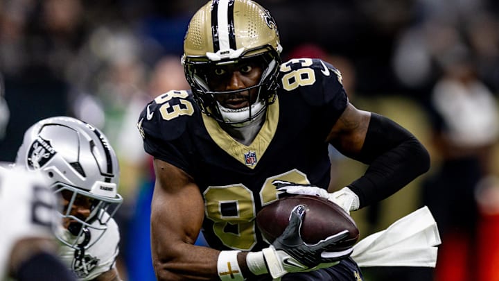 Dec 29, 2024; New Orleans, Louisiana, USA;  New Orleans Saints tight end Juwan Johnson (83) catches a pass against the Las Vegas Raiders during the first half at Caesars Superdome. Mandatory Credit: Stephen Lew-Imagn Images