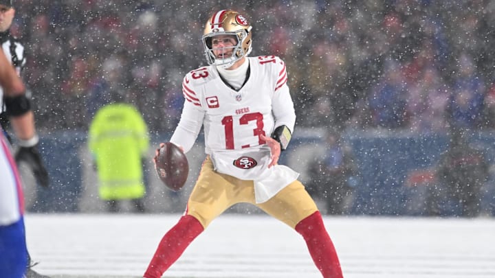 Dec 1, 2024; Orchard Park, New York, USA; San Francisco 49ers quarterback Brock Purdy (13) moves out of the pocket to throw a pass against the Buffalo Bills in the second quarter at Highmark Stadium. Mandatory Credit: Mark Konezny-Imagn Images