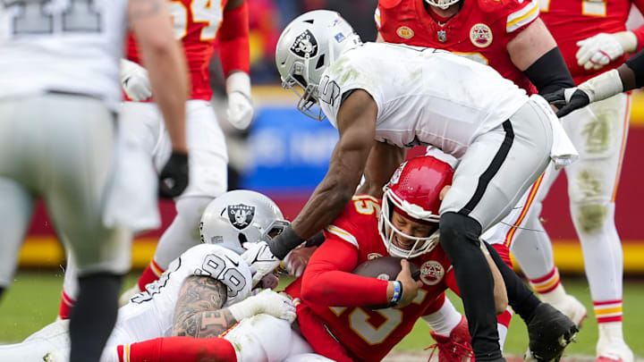 Dec 25, 2023; Kansas City, Missouri, USA; Kansas City Chiefs quarterback Patrick Mahomes (15) is tackled Las Vegas Raiders defensive end Maxx Crosby (98) and linebacker Divine Deablo (5) during the second half at GEHA Field at Arrowhead Stadium. Mandatory Credit: Jay Biggerstaff-Imagn Images Dec 25, 2023; Kansas City, Missouri, USA; Kansas City Chiefs quarterback Patrick Mahomes (15) is tackled Las Vegas Raiders defensive end Maxx Crosby (98) and linebacker Divine Deablo (5) during the second half at GEHA Field at Arrowhead Stadium. Mandatory Credit: Jay Biggerstaff-Imagn Images