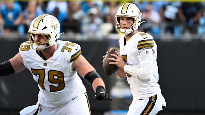 Nov 9, 2025; Charlotte, North Carolina, USA;  New Orleans Saints quarterback Tyler Shough (6) looks to pass as center Luke Fortner (79) blocks in the fourth quarter at Bank of America Stadium. Mandatory Credit: Bob Donnan-Imagn Images