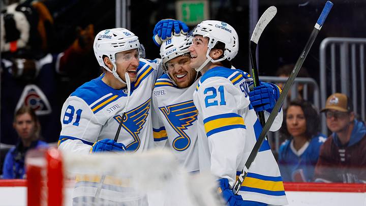 Apr 5, 2026; Denver, Colorado, USA; St. Louis Blues center Robert Thomas (18) celebrates his third goal of the game with left wing Dylan Holloway (81) and right wing Jimmy Snuggerud (21) in the third period against the Colorado Avalanche at Ball Arena. Mandatory Credit: Isaiah J. Downing-Imagn Images